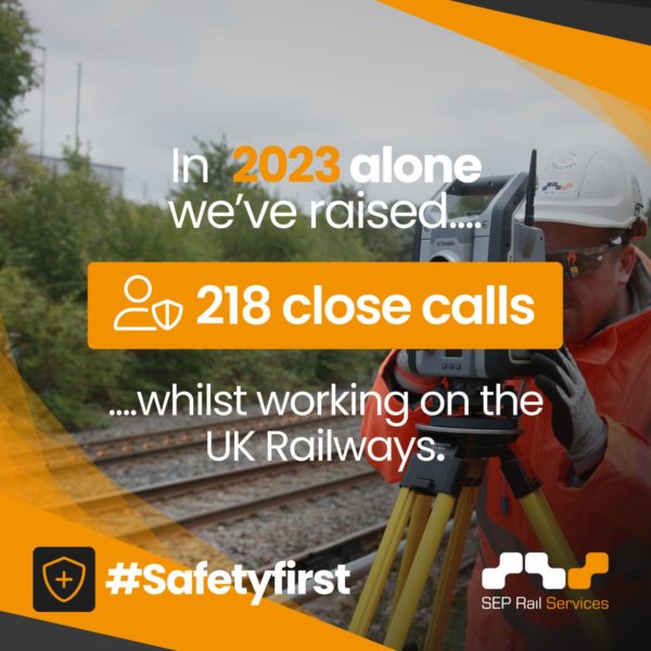 Construction worker in hard hat using surveying equipment on UK railway tracks, highlighting "218 close calls" for safety awareness in 2023 by SEP Rail Services. #Safetyfirst